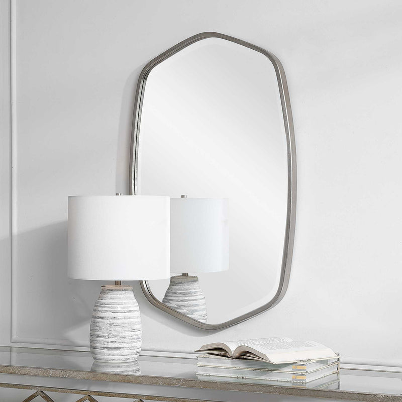 Uttermost Duronia iron wall mirror with a sleek, modern frame and reflective glass surface for stylish home decor.
