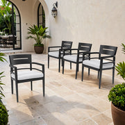 Set of four Life Outside outdoor patio dining chairs with black tapered legs and Sunbrella fabric cushions for outdoor comfort.