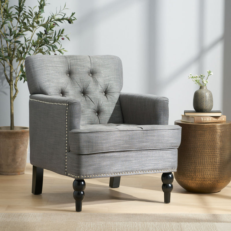 Noble House Harrison tufted club arm chair with button-tufted back and birch wood legs, upholstered in plush fabric.
