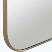 Uttermost Taft wall mirror with a sleek, modern frame hanging on a wall, showcasing contemporary home decor style.