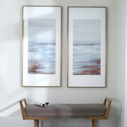 Set of two Coastline framed prints by Uttermost featuring light brown ocean-inspired artwork in sleek frames.