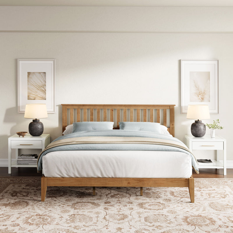 Ridgecrest Home Malinda panel bed with a classic wooden frame and headboard, shown in a cozy bedroom setting.