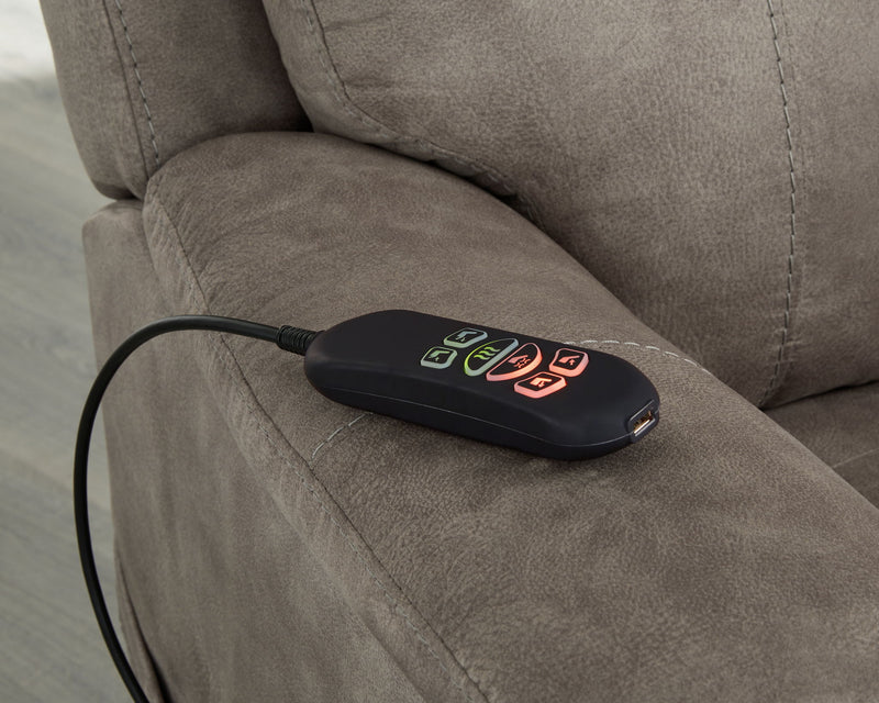 Signature Design by Ashley Crestmeade Power Lift Recliner in plush fabric, showing its padded armrests and adjustable reclining mechanism.