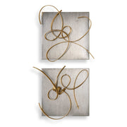 Set of two gold metal wall art pieces by Uttermost, modern wall decor with intricate geometric designs.