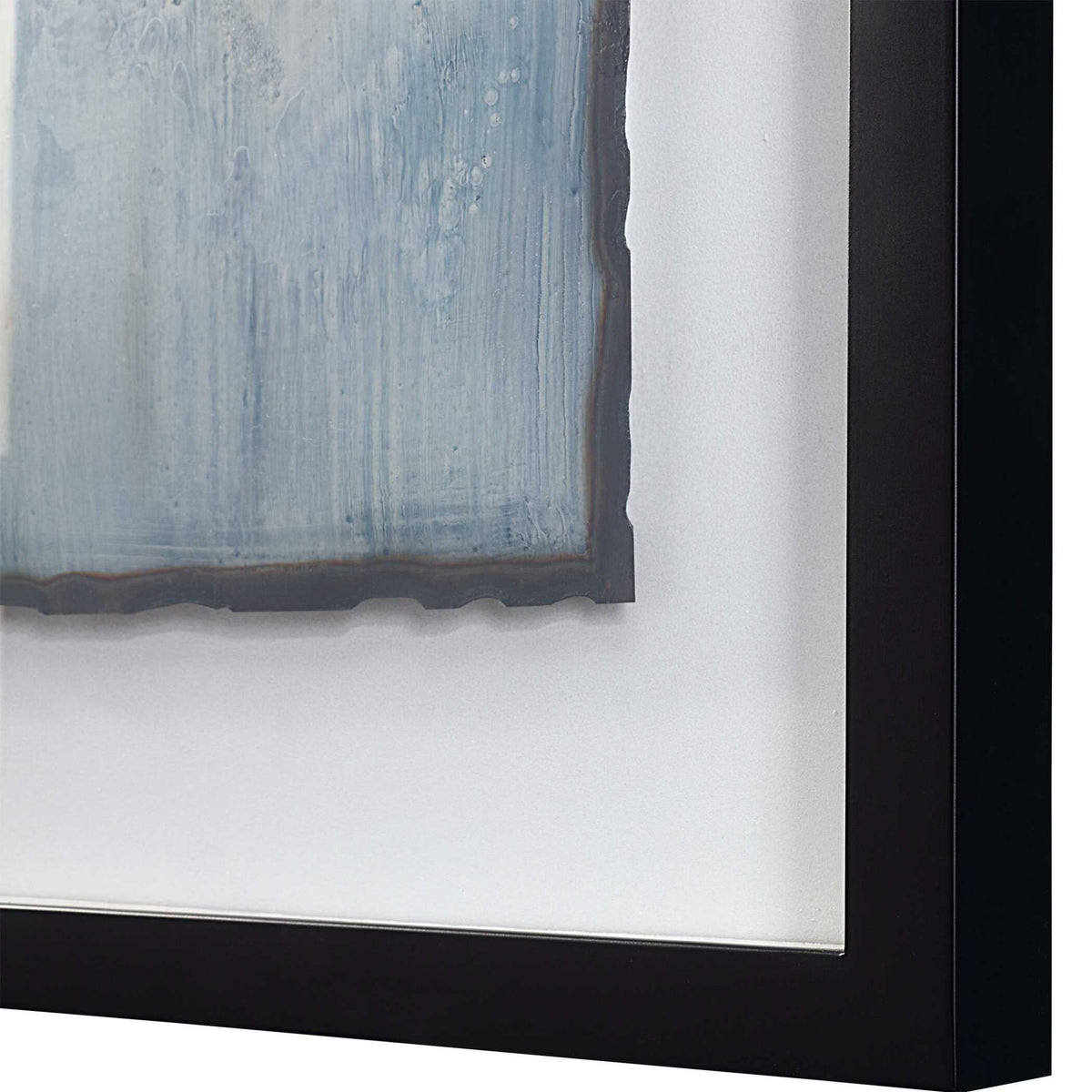 Set of two framed abstract prints featuring blue glimmering agate designs by Uttermost, displayed side by side on a wall.