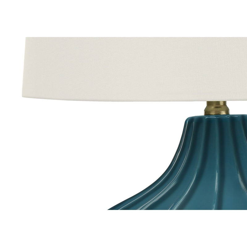 Blue ceramic table lamp with a transitional design by 8th Street, featuring a stylish and functional lighting fixture.