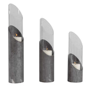 Set of three Uttermost Karter iron and glass candleholders in pearl silver and dark gray with elegant cylindrical design.