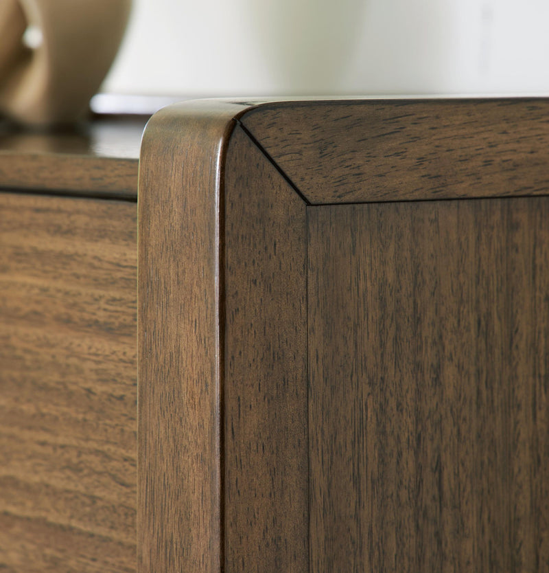 Benchcraft® Marxmore brown five-drawer accent chest with sleek design and ample storage in a modern living space.