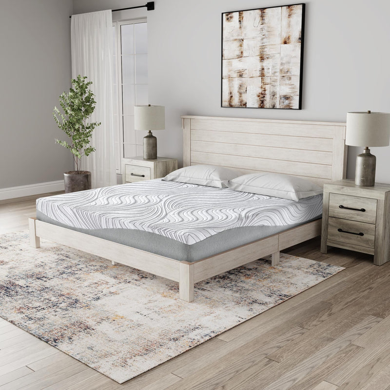 Sierra Sleep Essentials Firm Memory Foam Mattress with plush top layer and supportive base, shown on a bed frame inside a bedroom.