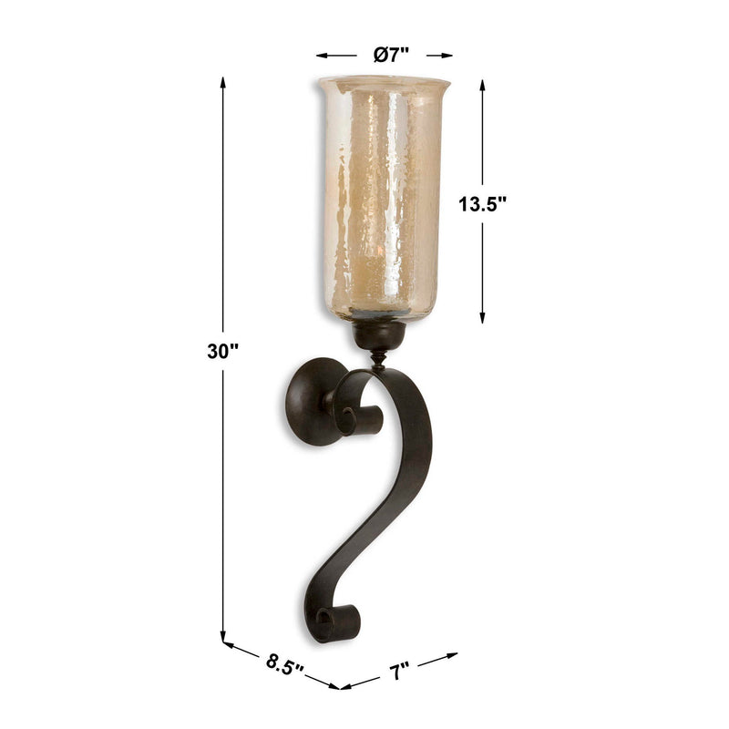 Uttermost Joselyn bronze candle wall sconce with curved arm and candle holder, mounted on a wall for elegant lighting.