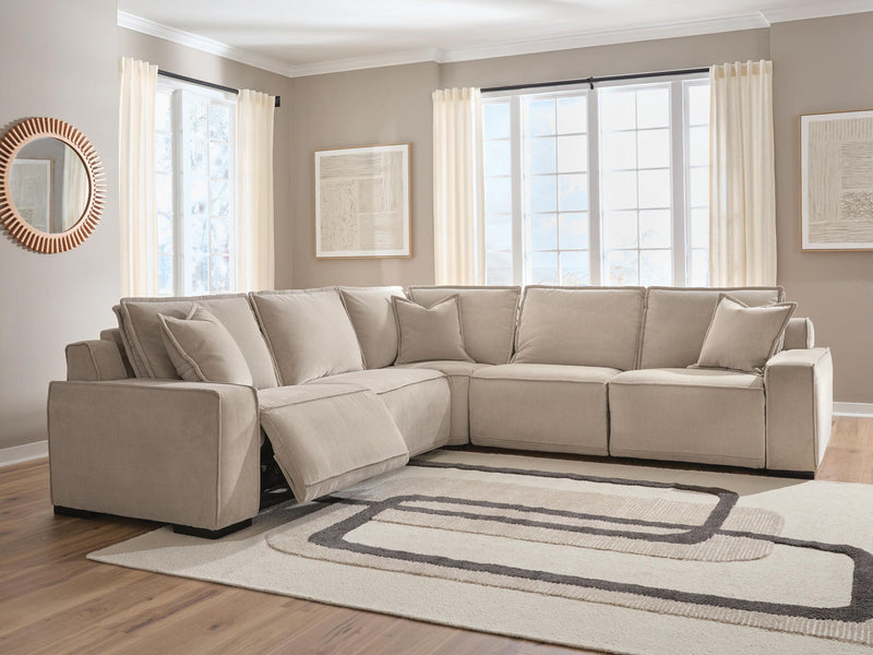 Benchcraft Carceri reclining sectional with plush fabric and multiple seating options, shown in a modern living room setting.