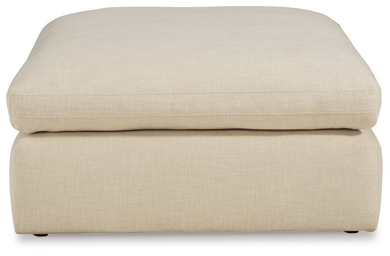 Elyza oversized ottoman by Benchcraft® in a neutral fabric, serving as a stylish accent piece for living rooms or lounges.