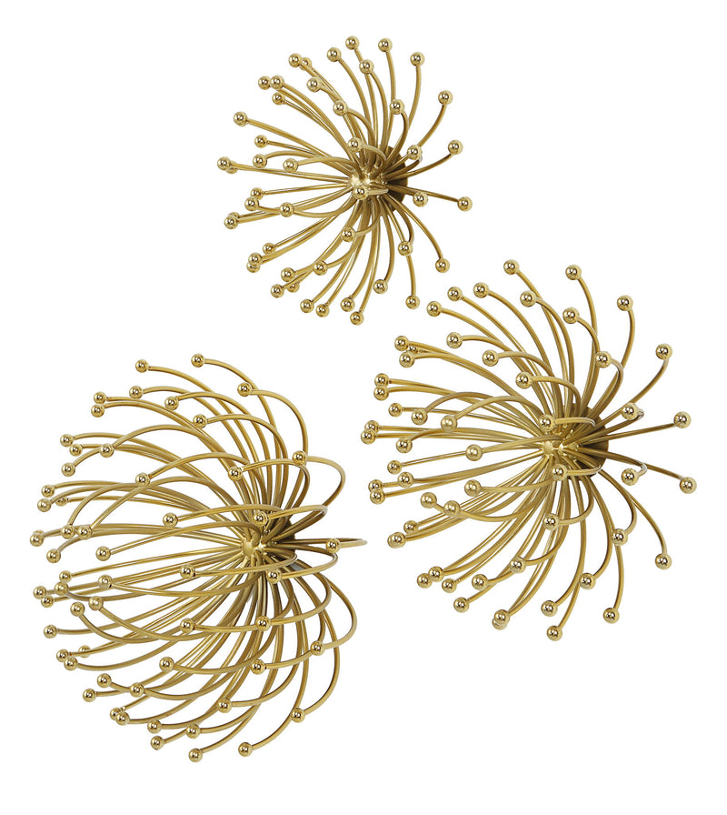 Set of three gold metal wall decor panels by Uttermost featuring modern geometric designs for stylish wall accents.