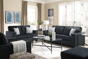 Signature Design by Ashley Altari sleeper sofa with plush fabric, featuring a folded-out bed and modern design in a living room setting.