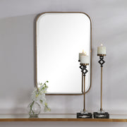 Gold Malay vanity mirror by Uttermost featuring a sleek, modern design with a reflective glass surface and gold-toned frame.