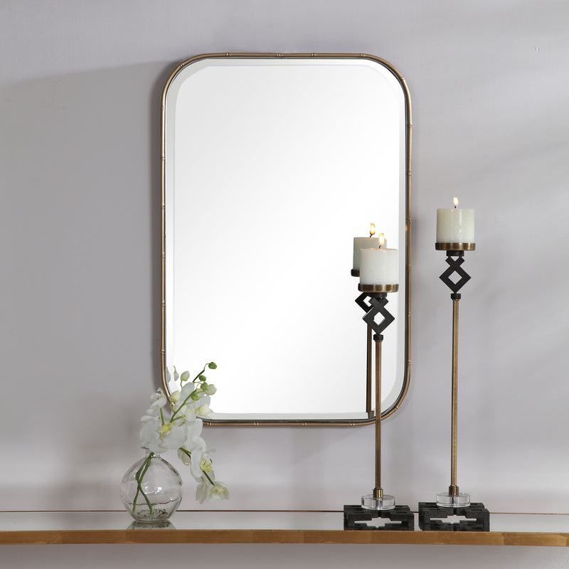 Gold Malay vanity mirror by Uttermost featuring a sleek, modern design with a reflective glass surface and gold-toned frame.