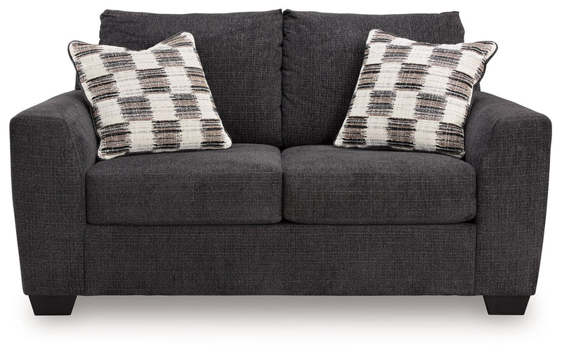 Loreo stationary loveseat by Benchcraft® with plush fabric and cushioned armrests, perfect for cozy living room seating.