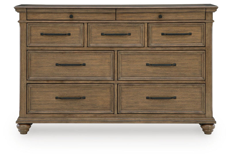Signature Design by Ashley Karallin dresser with multiple drawers in warm wood finish, showcasing modern bedroom storage furniture.