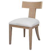 Uttermost Idris armless side chair with upholstered seat and wooden legs, modern design, shown from a front angle.