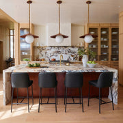Set of two TOV Furniture Sydney counter stools with wooden legs and cushioned seats, ideal for kitchen or bar area.