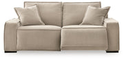 Benchcraft Carceri reclining sectional sofa with plush cushions and reclining features, shown in a modern living room setting.