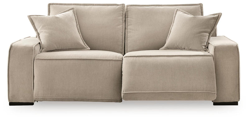 Benchcraft Carceri reclining sectional sofa with plush cushions and reclining features, shown in a modern living room setting.