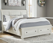 Ashley Robbinsdale sleigh bedroom set with six pieces, including a bed frame, dresser, and nightstands in a classic wood finish.