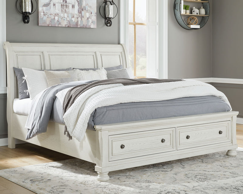 Ashley Robbinsdale sleigh bedroom set with six pieces, including a bed frame, dresser, and nightstands in a classic wood finish.