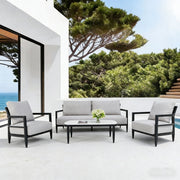 Life Outside 4-piece outdoor conversation set with chairs, bench sofa, tables, and Sunbrella cushions in a backyard setting.