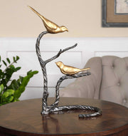 Black and gold birds on a limb sculpture by Uttermost, decorative figurine featuring detailed bird and branch design.