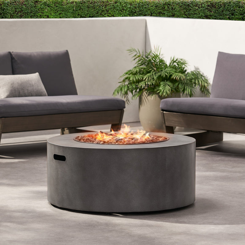 Round Noble House iron fire pit with 40,000 Btu, featuring a sturdy metal design and a spacious top for outdoor fires.