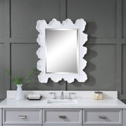 Uttermost Sea Coral wall mirror featuring a detailed coral-inspired frame with a round shape and reflective glass surface.