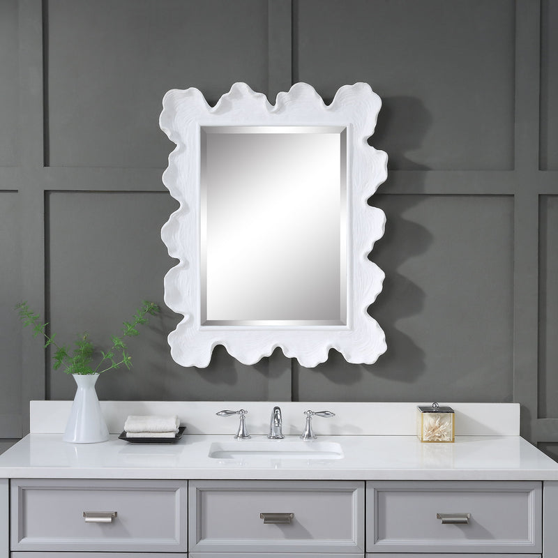 Uttermost Sea Coral wall mirror featuring a detailed coral-inspired frame with a round shape and reflective glass surface.