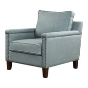 Uttermost Charlotta accent chair in sea mist fabric with a curved wooden frame and plush cushioning.