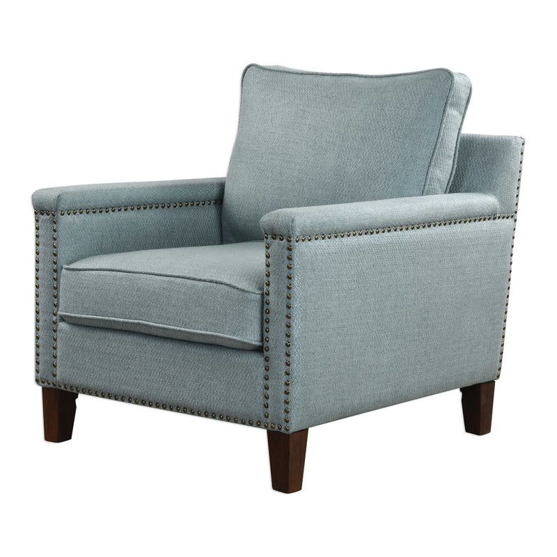Uttermost Charlotta accent chair in sea mist fabric with a curved wooden frame and plush cushioning.