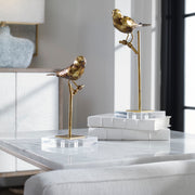 Pair of light brown bird sculptures from Uttermost, detailed passerine bird figurines in a decorative sculpture set.