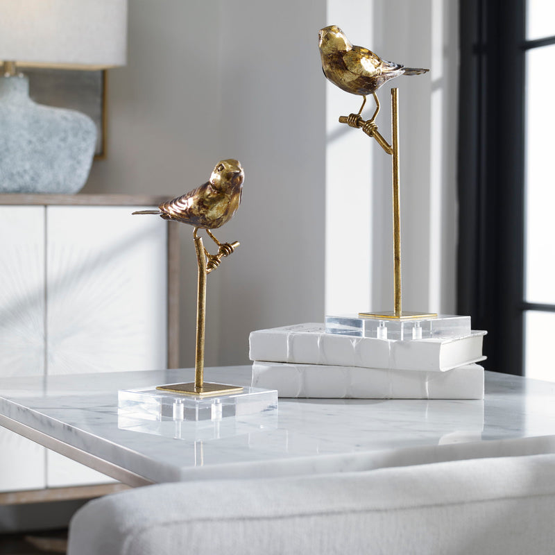 Pair of light brown bird sculptures from Uttermost, detailed passerine bird figurines in a decorative sculpture set.