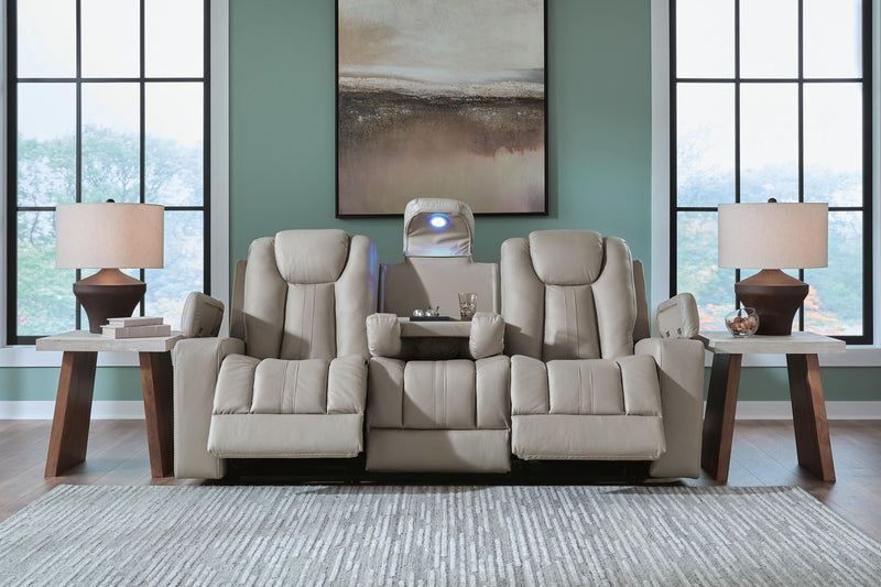 Signature Design by Ashley Elevate Edges reclining sofa with drop-down table in coin fabric, showing plush cushions and built-in table.