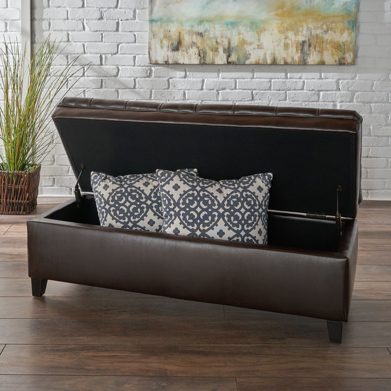 Noble House Juliana storage ottoman with beige fabric and birch wood legs, showing its cushioned top and open storage compartment.