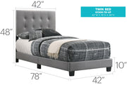 Upholstered Caldwell bed by Glory Furniture with a padded headboard and neutral fabric, shown in a modern bedroom setting.