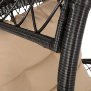 Noble House outdoor wicker standing basket accent chair with cushion, featuring a woven wicker design and comfortable seating.