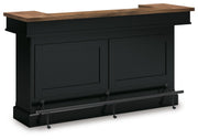 Wildenauer brown and black bar table by Signature Design Ashley, featuring a sleek, modern design with sturdy legs and spacious surface.