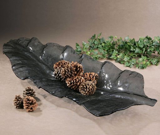 Dark gray smoked leaf glass tray by Uttermost, featuring a sleek, modern design perfect for serving or decorative display.