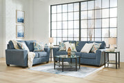 Signature Design by Ashley Cashton living room set with stationary chair and ottoman, featuring plush upholstery and contemporary style.
