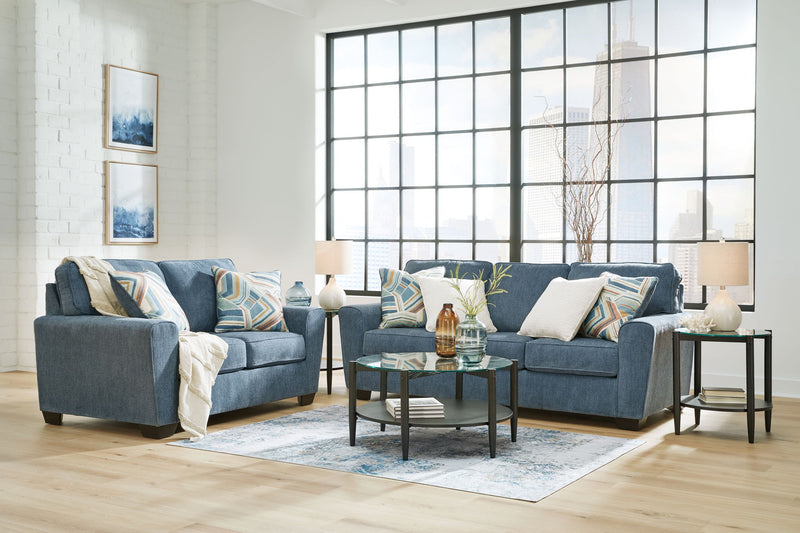 Signature Design by Ashley Cashton living room set with stationary chair and ottoman, featuring plush upholstery and contemporary style.