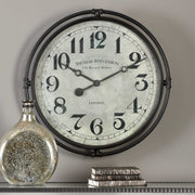 Nakul Industrial Wall Clock by Uttermost featuring a pearl silver finish and modern design, hanging on a wall.