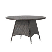 Noble House Corsica round dining table in warm brown wood finish, perfect for modern dining rooms.
