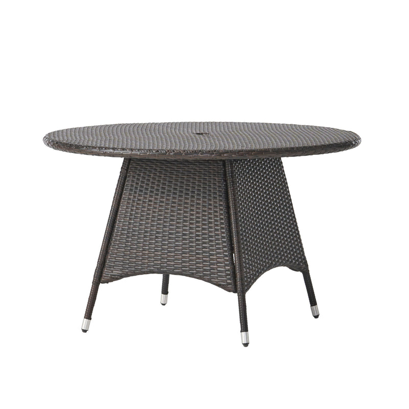Noble House Corsica round dining table in warm brown wood finish, perfect for modern dining rooms.