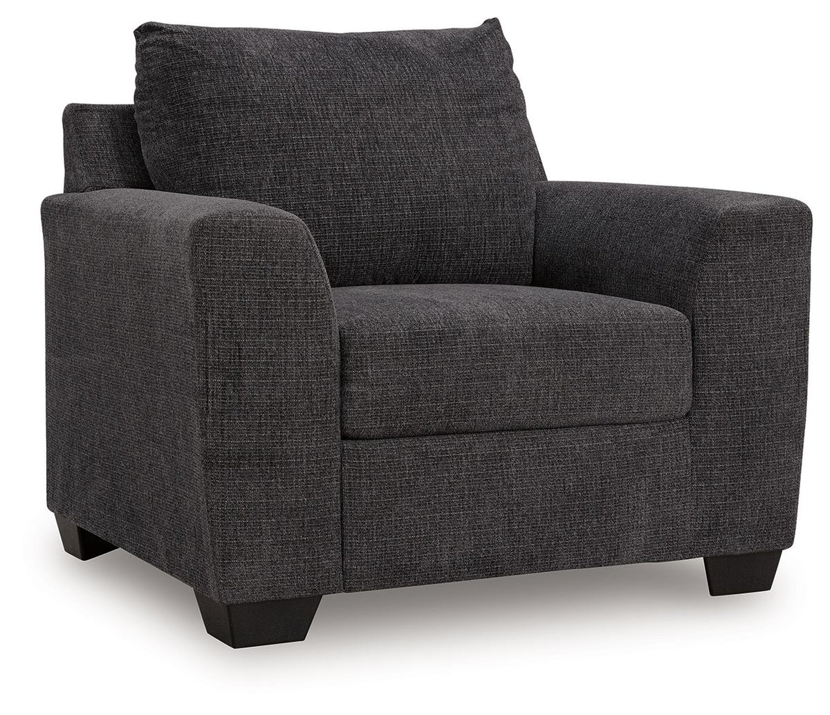 Benchcraft® arm chair with plush upholstery and wooden legs, showcasing a modern design perfect for living room seating.
