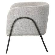 Uttermost Jacobsen accent chair with plush upholstery and wooden legs, showcasing a stylish and comfortable seating option.